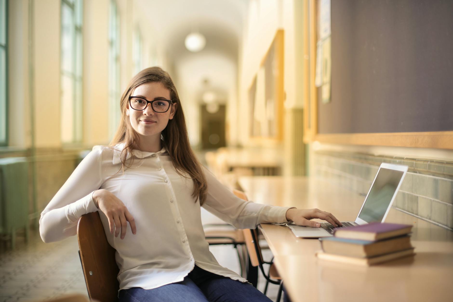 woman in white long sleeve shirt sitting on chair