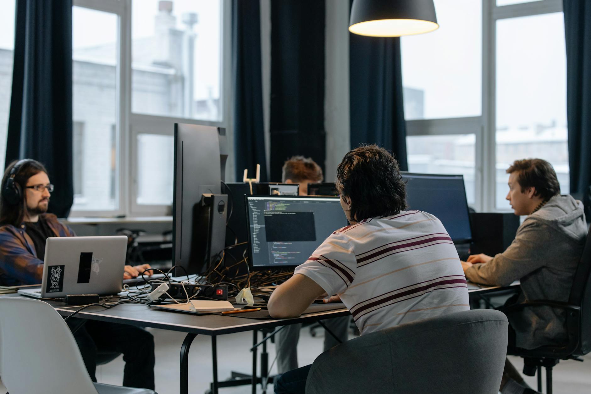 ruby on rails developers sitting at desks in an office and using computers